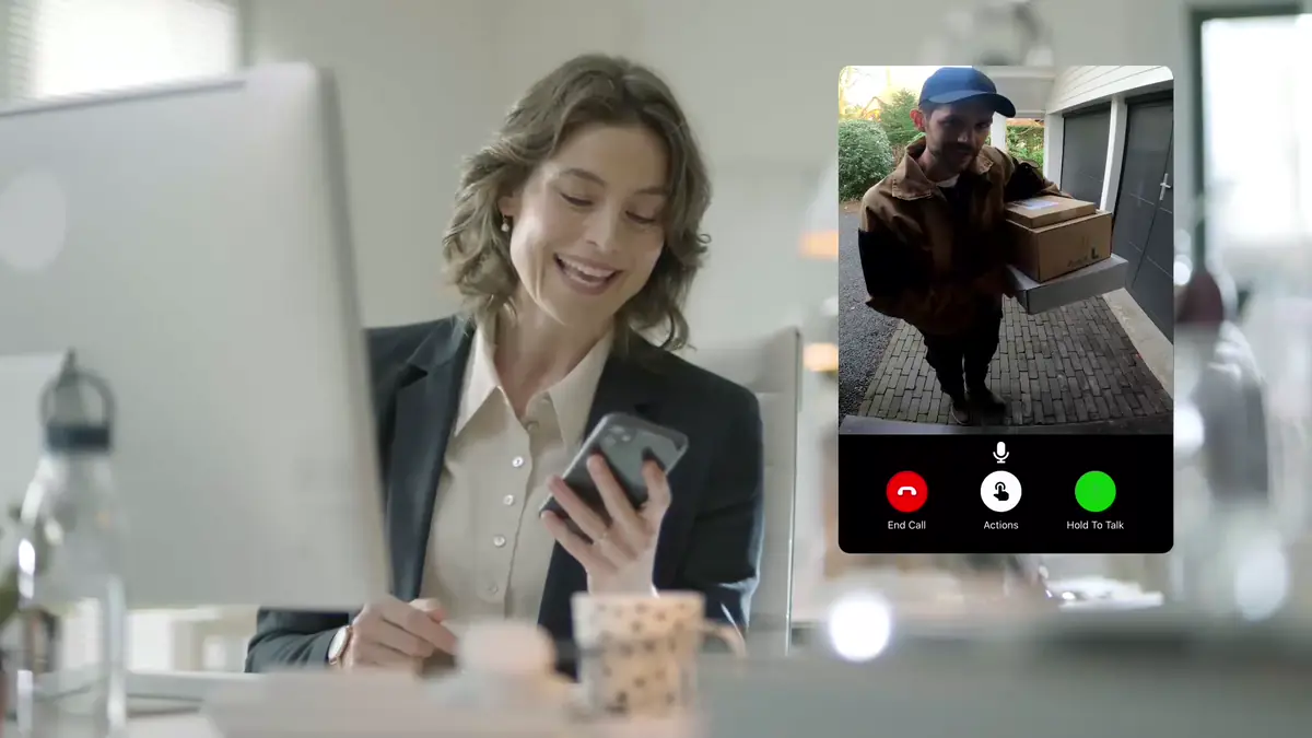 Homeowner answering a video doorbell call from her phone at work